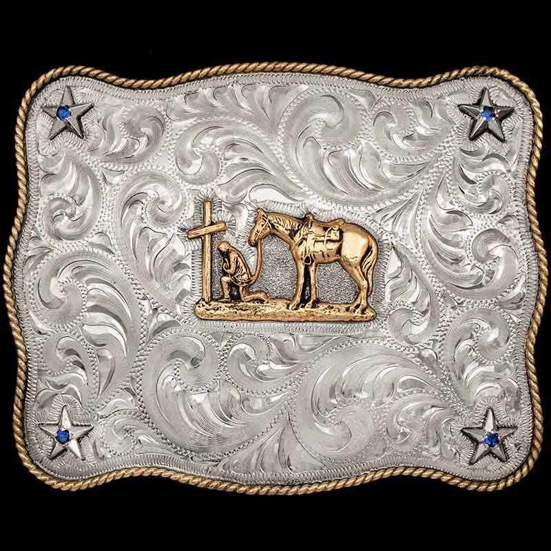 A men's belt buckle with the figure of a praying cowboy
