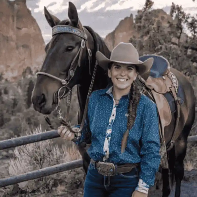 Cowgirl wit her horse and a western belt buckle