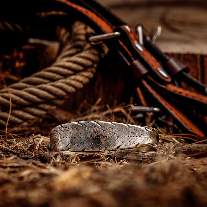 Silver Cuff Bracelet in the shape of a feather in a western set
